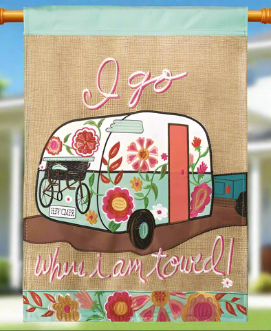 Decorative banner with floral camper design and text on a burlap background