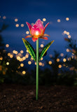 Solar-powered flower light with pink and orange petals on a white background