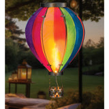 Rainbow XLG Hot Air Balloon Solar Lantern illuminated with colorful lights in an outdoor setting.