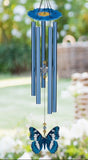 Blue butterfly wind chime in a garden setting