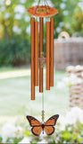 Decorative wind chime with butterfly charm in a garden setting