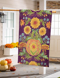Decorative house flag with floral and pumpkin design hanging on a door