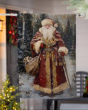 Decorative banner with a detailed illustration of Santa Claus in a snowy landscape, hanging outdoors.