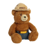 Smokey Bear Plush, a cuddly forest conservation figure with ranger hat and jeans, promoting wildfire prevention.
