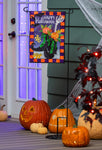 Halloween-themed decorations with pumpkins and a decorative sign on a porch.