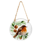Woodland Storybook Suncatchers featuring a hand-painted bird design with pine cones and greenery.