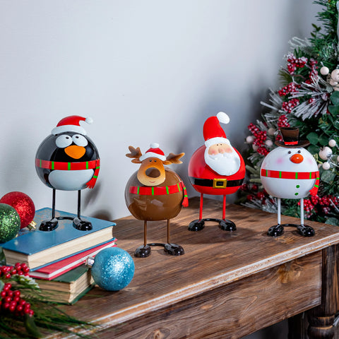 Wobbling Christmas Characters Table Decor featuring Santa, Reindeer, Snowman, and Penguin on a wooden table.