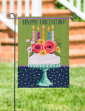 Garden flag with birthday cake design featuring candles and flowers on a green background.