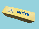 Block of butter with 'Salted Butter' text on a gray surface