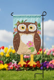 Decorative garden flag with an owl design on a white background