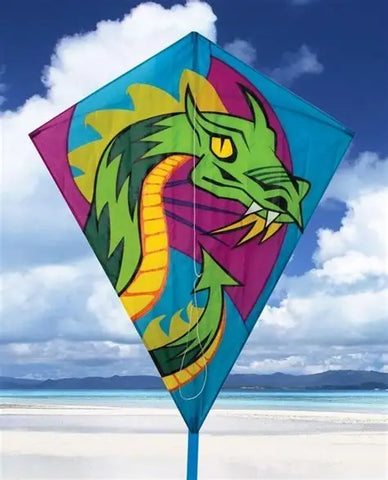 Colorful dragon kite against a blue sky with clouds and beach in the background