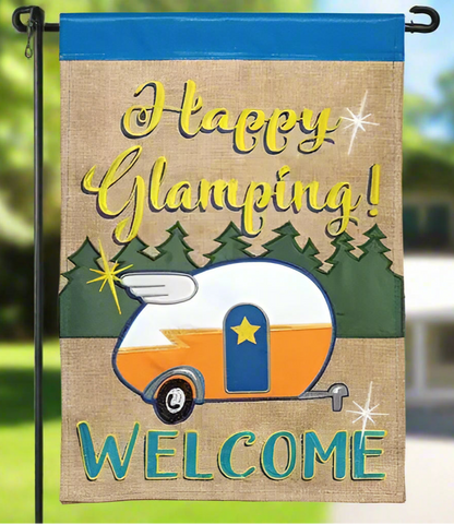 Decorative flag with 'Happy Glamping! Welcome' text and a camper design on a burlap background.