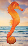 Orange seahorse-shaped object on a white background