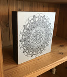 Decorative box with a mandala design on a white background
