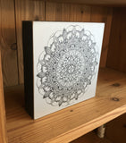 Decorative box with a mandala design on a white background